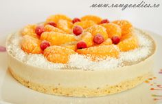 a cake on a plate with powdered sugar and fruit toppings, ready to be eaten