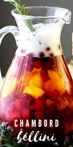 a pitcher filled with fruit sitting on top of a table