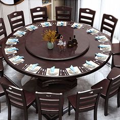 a round dining table with chairs around it