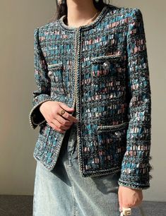 Handmade with meticulous care and attention to detail, this tweed boucle jacket in multi blue is a true standout piece in any wardrobe. The intricate weave of the tweed fabric gives it a rich texture and a unique look that catches the eye. Adding to its charm, the jacket features candy raisin buttons that provide a pop of color and a playful touch to the classic design. The combination of the multi-blue tweed and the candy raisin buttons creates a harmonious contrast that is both sophisticated a Luxury Tweed Jacket Made Of Suiting Fabric, Tweed Boucle Jacket, Blue Tweed, Chanel Jacket, Boucle Jacket, Tweed Fabric, Double Breasted Jacket, Blue Jacket, Blouse Designs