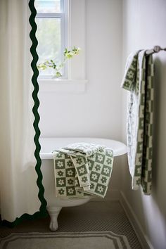 a white bath tub sitting next to a window