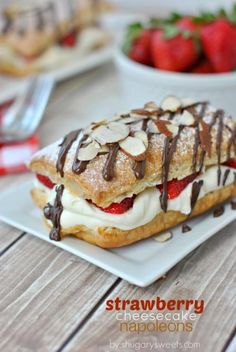 strawberry shortcakes with chocolate drizzle and almonds on a white plate