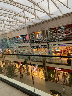 the inside of a shopping mall with people walking around