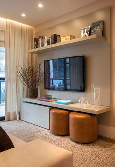 a living room with a large tv on the wall