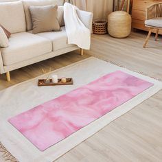 a living room with a couch, rug and coffee table on the floor in front of it