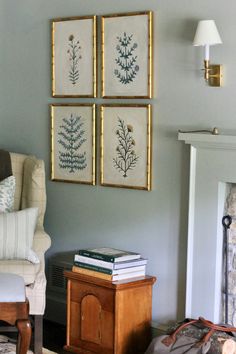 a living room filled with furniture and paintings on the wall