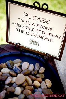 there is a sign that says please take a stone and hold it during the ceremony