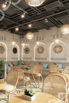 an indoor seating area with wicker chairs and round wooden tables surrounded by hanging lights