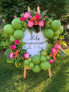 a sign that says aloh where glad you're here made with green apples and pink flowers