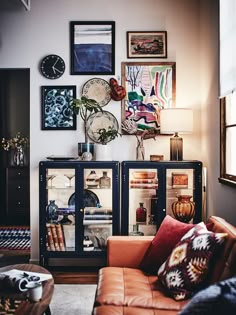 a living room filled with furniture and pictures on the wall