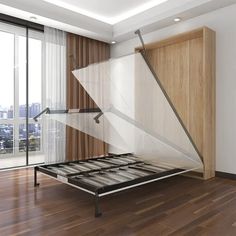 an empty bed frame in the middle of a wooden floored room with sliding glass doors