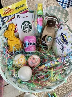 a basket filled with lots of different types of candy and candies on top of a table