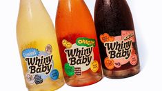 three bottles of different flavored drinks on a white background