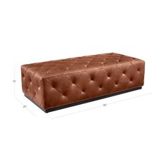 a brown ottoman sitting on top of a white floor