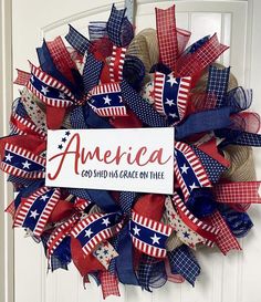 a patriotic wreath that says america god said us grace on me with red, white and blue ribbons