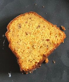 a piece of bread sitting on top of a black plate