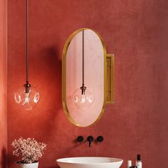 a sink and mirror in a room with red walls