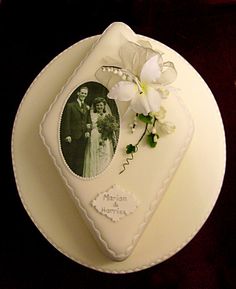 a wedding cake with a photo and flowers on it