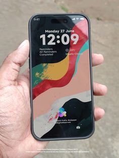 someone is holding up their iphone with the time displayed on it's display screen