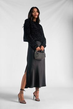 Say hello to the "Renzo" set - where comfort meets sophistication. The fuzzy sweater with its subtle shiny details exudes casual elegance. Paired with a metallic silky maxi skirt, it strikes a perfect balance between modesty and high fashion. Renzo is crafted for the modern woman seeking both style and comfort in one effortlessly chic ensemble. Elevate your wardrobe with this versatile blend of cozy and glamorous - because looking fabulous should always feel this good. Elegant Slip Dress Outfit, Sweater And Slip Dress, Black Dress With Sweater Over It, Sweater Over Slip Dress, Layered Slip Dress Outfit, Slip Dress And Sweater, Sweater And Dress Layering, Slip Dress With Sweater, Maxi Dress With Sweater