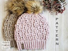 two knitted hats with fur pom - poms on top of each other