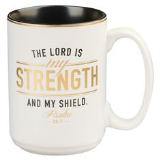 the lord is my strength and my shield white coffee mug with gold lettering on it