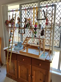 a kitchen island with various items on it and ladders hanging from the ceiling above