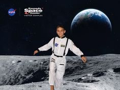 a man in an astronaut's suit standing on the moon with his arms outstretched