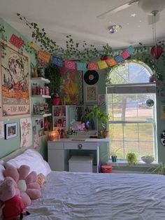 a bedroom decorated in pastel green and pink with lots of decorations on the wall