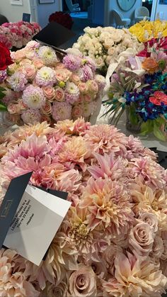 a bunch of flowers that are sitting on a table with a price tag in front of them