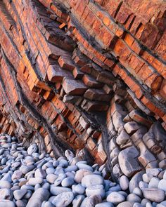 some rocks and wood are stacked on top of each other