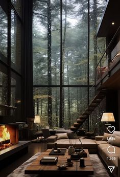 a living room filled with furniture and a fire place in front of a windowed wall