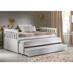 a white day bed with trundle and drawers