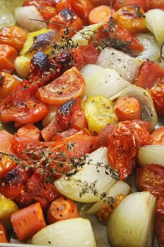 tomatoes and onions are being cooked in a pan