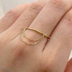 One piece of Dainty 9K SOLID Gold Dangle Chain band ring, great additional piece for your wardrobe * Metal: 9K solid yellow gold * Stamp: 9K * Band width: 1.15mm * Chain width: 0.85mm 📌Production time: 3-4 weeks if you need any other size, please msg us for more info. Want White or Rose gold?⬇️ DM us directly  Want to check out more rings?⬇️ https://etsy.me/2MyjnPw ❤️Follow us on Instagram @ elekalonjewelry for latest projects and designs. *If you have any questions, please feel free to message Wishbone Necklace Gold, Minimal Gold Jewelry, Gold Chain Ring, Dangle Ring, Gold Finger Rings, Must Have Jewelry, Razzle Dazzle, Gold Band Ring, Ring Crafts