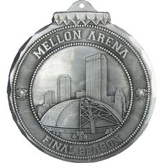 a metal medal with the name melon arena in front of a cityscape