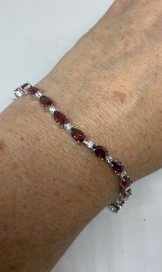 Vintage Bohemian Red Garnet and Cubic Zirconia Bracelet 925 Sterling Silver bracelet is very lively and bright.   The stones are deep colors and well matched.   The sterling silver is plated with rhodium to protect the bracelet from tarnish This is 7.5 inch My jeweler can shorten for a $20 fee.  All jewelry is shipped free in the US in a nice gift box.   Check out our over a THOUSAND great reviews Engraving is $4 per letter and is not always perfect depending on the piece. It can take a few days Fine Jewelry Red Cubic Zirconia Tennis Bracelet, Red Cubic Zirconia Tennis Bracelet, Red Cubic Zirconia Tennis Bracelet With Gemstones, Red Cubic Zirconia Tennis Bracelet For Anniversary, Red Gemstone Tennis Bracelet In Fine Jewelry Style, Red Gemstone Tennis Bracelet Fine Jewelry, Red Gemstone Tennis Bracelet, Red Gemstone Tennis Bracelet For Anniversary, Red Cubic Zirconia Bracelets For Anniversary