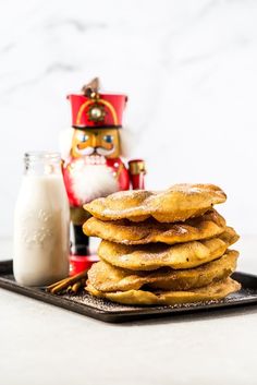 a stack of pancakes sitting on top of a black plate