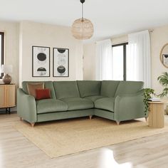 a living room with a large green couch