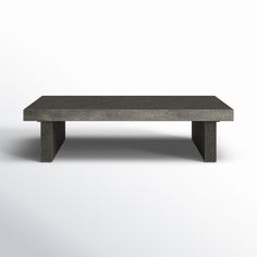 a concrete coffee table sitting on top of a white floor