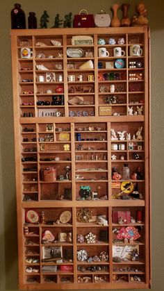 a wooden shelf filled with lots of different items