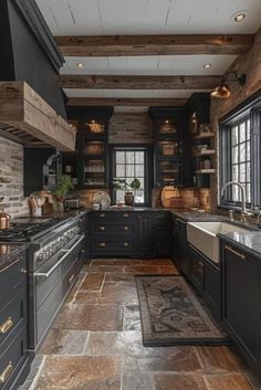 a kitchen with black cabinets and stone flooring is pictured in this image, there are many