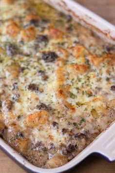 a casserole dish with meat and cheese in it sitting on a table top