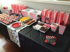 a table topped with lots of different types of snacks and desserts on top of it