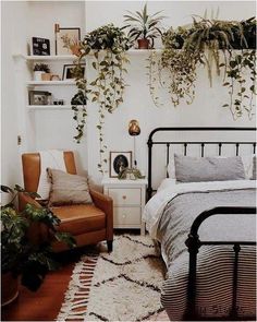 a bed room with a neatly made bed and lots of plants