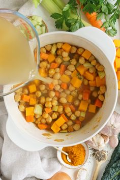 a bowl filled with chickpeas, carrots and celery next to other vegetables