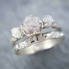 a close up of a ring with three stones on it's sides and one stone in the middle