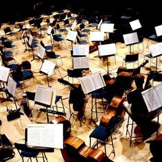 an orchestra room full of musical instruments and sheet music