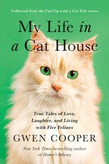 a white cat with green eyes sitting in front of a book cover that says, my life in a cat house