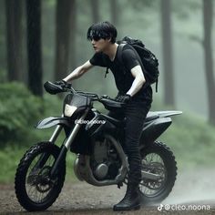 a young man riding on the back of a motorcycle in the rain with an umbrella over his head